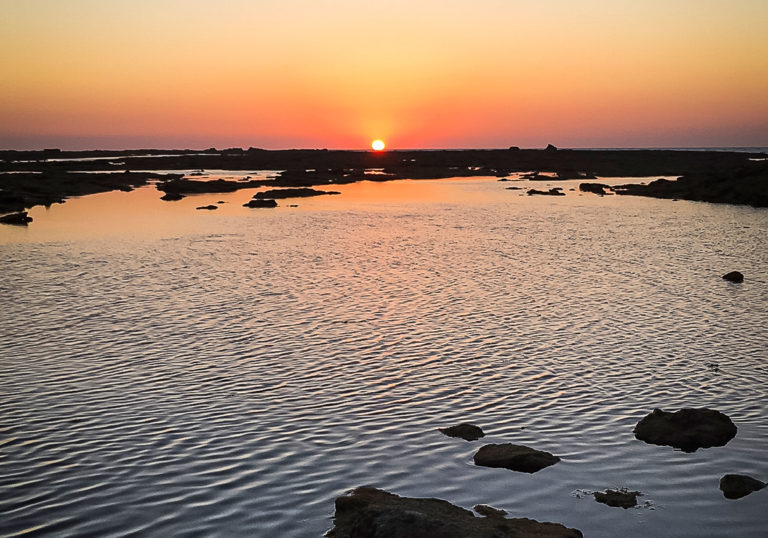 Sunset over the city beach