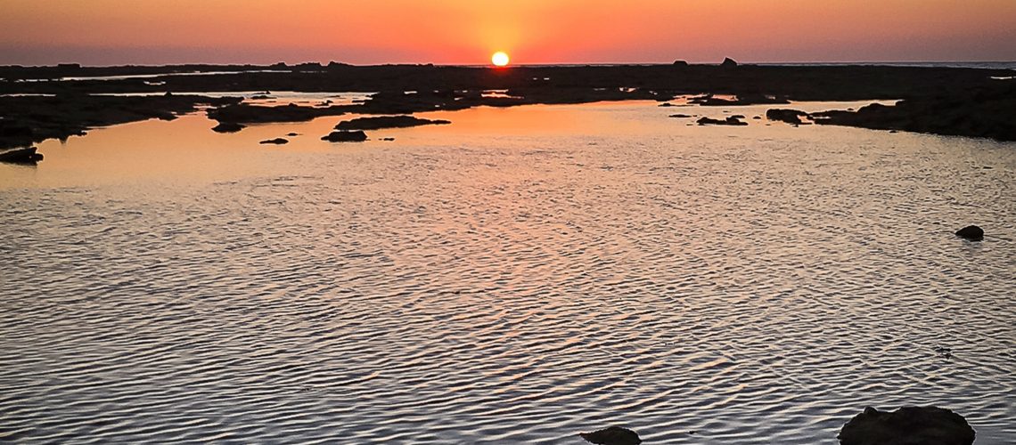 Sunset over the city beach